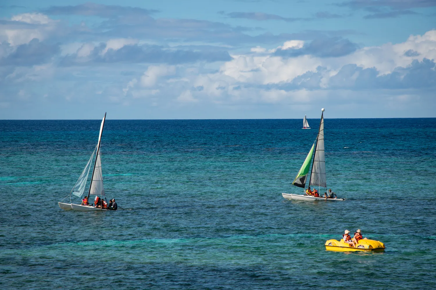 Open blue water with sailing and paddling activity